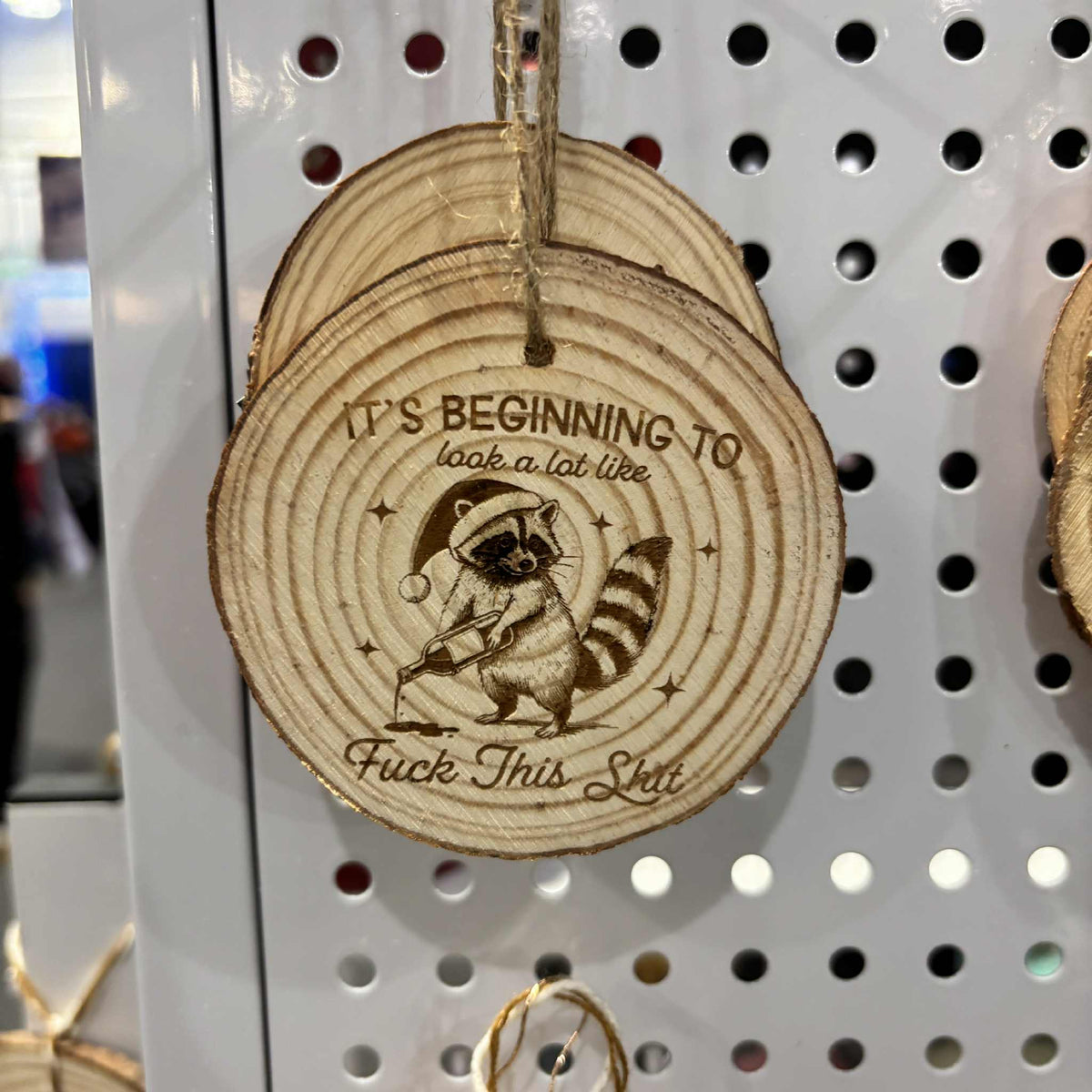 Wood slice Christmas ornament with "Fuck this Shit" laser-engraved raccoon design