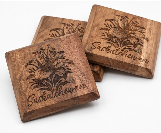 Set of wooden coasters with etched prairie lily design and Saskatchewan lettering