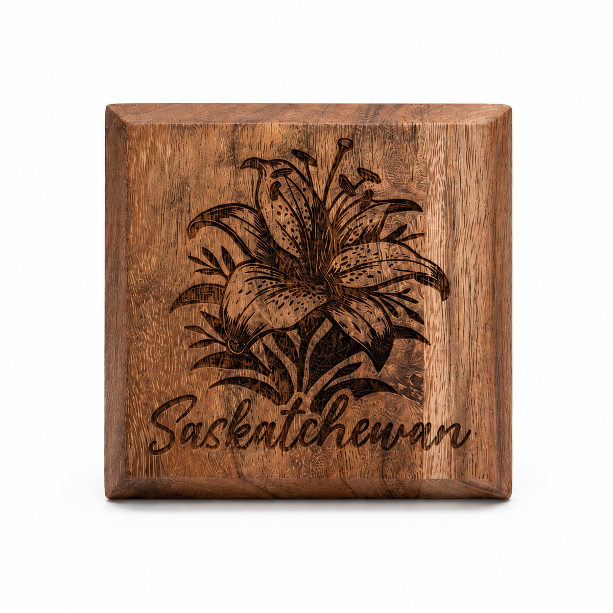 Close-up of wooden coaster with etched prairie lily flower design